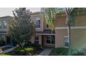 Welcoming townhome with mature trees, enhancing curb appeal at 9752 Trumpet Vine Loop, Trinity, FL 34655