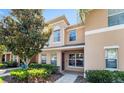 Charming townhome entrance with lush greenery and a well-lit pathway at 9752 Trumpet Vine Loop, Trinity, FL 34655