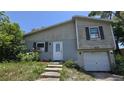 Two-story home featuring a quaint entryway and attached one car garage at 1107 Goshen Rd, Tarpon Springs, FL 34689