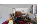 Attached garage space showing storage area with scattered items at 1107 Goshen Rd, Tarpon Springs, FL 34689