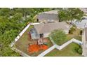 Spacious fenced backyard with a screened lanai, playground set, and ample space for outdoor activities at 11123 Silver Dancer Dr, Riverview, FL 33579