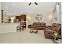 Open-concept living area featuring neutral tile flooring, comfortable seating, and seamless flow to the kitchen at 11123 Silver Dancer Dr, Riverview, FL 33579