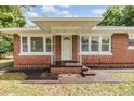 Charming front porch with decorative supports leads to a classic brick home's inviting entrance at 1511 East Emma St. E St, Tampa, FL 33610