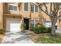 Charming townhome with a one-car garage, well-maintained landscaping, and inviting front entrance at 16314 Parkstone Palms Ct, Tampa, FL 33647