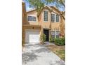 Charming townhome with a one-car garage, well-maintained landscaping, and inviting front entrance at 16314 Parkstone Palms Ct, Tampa, FL 33647