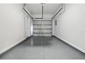 Clean, spacious one-car garage featuring an epoxy floor and convenient interior access at 16314 Parkstone Palms Ct, Tampa, FL 33647