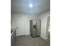 A modern, stainless steel refrigerator in a bright kitchen with sleek, light woodgrain floors at 1807 E Bougainvillea Ave, Tampa, FL 33612