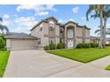 Well-maintained two-story home with a long driveway, manicured lawn, and mature landscaping at 18219 Bittern Ave, Lutz, FL 33558