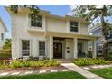 Beautiful home with a covered porch, elegant landscaping, and a stone walkway leading to the front door at 2522 W Watrous Ave, Tampa, FL 33629