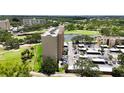 Condominium building with manicured green space, convenient parking, and serene water views at 2616 Cove Cay Dr # 505, Clearwater, FL 33760
