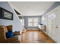 Bright foyer with hardwood floors, staircase, and transom window in the front door at 310 N Lincoln Ave, Clearwater, FL 33755