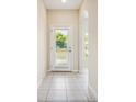 Bright entryway with tile flooring and an arched doorway at 31215 Flannery Ct, Wesley Chapel, FL 33543