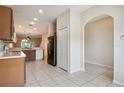 Open kitchen features tile flooring and black appliances at 31215 Flannery Ct, Wesley Chapel, FL 33543
