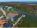 Waterfront home with a private dock, boat lift, and screened-in pool area on the canal at 3397 Bluefish Dr, Hernando Beach, FL 34607