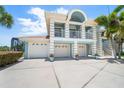 Charming two-story coastal home with a three-car garage and well-manicured landscaping at 3397 Bluefish Dr, Hernando Beach, FL 34607