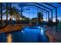 Captivating indoor pool area features a serene waterfall and lush tropical landscaping at 3397 Bluefish Dr, Hernando Beach, FL 34607