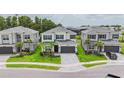 Charming two-story home with a stone driveway, well-manicured lawn and lush landscaping at 3541 Great Banyan Way, Wesley Chapel, FL 33543