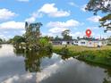 Waterfront property featuring a scenic view with mature trees, lush greenery and a peek at the house at 3552 Middletown St, Port Charlotte, FL 33952