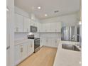 Bright kitchen featuring stainless steel appliances, white cabinets, and quartz countertops at 3816 N Maryland Ave, Plant City, FL 33565