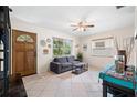 Bright and airy living room with tile floors, ceiling fan, and large windows at 4028 Queen N St, St Petersburg, FL 33714