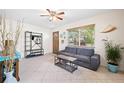 Cozy living room with tile floors, ceiling fan, and lots of natural light at 4028 Queen N St, St Petersburg, FL 33714