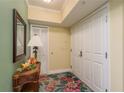 Condo hallway decorated with small table, mirror, and nice lamps at 4516 Seagull Dr # 601, New Port Richey, FL 34652