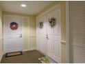 Inviting condo hallway with decorated doors at 4516 Seagull Dr # 601, New Port Richey, FL 34652