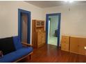 Cozy living room featuring hardwood floors, blue trim, and ample storage at 4526 Burlington N Ave, St Petersburg, FL 33713