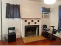 Living room with hardwood floors, decorative fireplace, and plenty of natural light at 4526 Burlington N Ave, St Petersburg, FL 33713