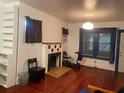 Bright living room with hardwood floors, decorative fireplace, and built-in shelving at 4526 Burlington N Ave, St Petersburg, FL 33713