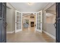 Open entryway with tile flooring, leading to living room with vaulted ceilings at 475 Holly Hill Rd, Oldsmar, FL 34677