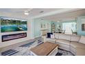 Bright living room with stylish decor, fireplace, and open-concept dining area at 500 20Th Ave, Indian Rocks Beach, FL 33785
