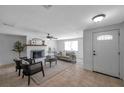 Bright living room featuring a decorative fireplace, neutral tones, and tile flooring at 5053 18Th St, Zephyrhills, FL 33542