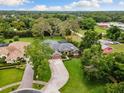 An aerial view of a beautiful single Gathering home surrounded by lush greenery and trees at 512 Creekside Ct, Safety Harbor, FL 34695