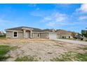 Charming single-story home with a two-car garage, complemented by a concrete driveway and front yard at 5441 Chestnut Ridge Rd, Dade City, FL 33523