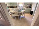Spacious kitchen with adjacent dining area, showcasing tile flooring and natural light at 5719 13Th E St, Bradenton, FL 34203
