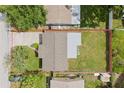 Aerial view showcases the property's layout and backyard, outlined in red, revealing its dimensions at 6941 58Th N Way, Pinellas Park, FL 33781
