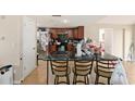 Kitchen featuring dark wood cabinets, black countertops, and tile floors at 8524 Winter Haven Dr, Hudson, FL 34667