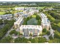 Drone view of the complex surrounding a pond and manicured landscaping at 960 Starkey Rd # 2103, Largo, FL 33771