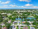 Expansive aerial view of a home nestled amidst lush greenery and a serene lake at 996 56Th S Ave, St Petersburg, FL 33705