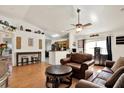 Comfortable living room with hardwood floors, ceiling fan, and seating for entertaining at 10401 Lakeside Vista Dr, Riverview, FL 33569