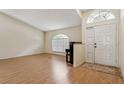 Inviting entryway with hardwood floors, vaulted ceiling, and ample natural light at 11638 Branch Mooring Dr, Tampa, FL 33635