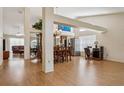Open-concept living space with hardwood floors connecting the dining area and kitchen at 11638 Branch Mooring Dr, Tampa, FL 33635