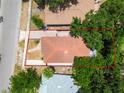 An aerial view showcases the roof, trees and the layout of the yard of the residence at 120 Bosphorous Ave, Tampa, FL 33606