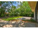 The backyard offers a cozy stone patio surrounded by lush tropical landscaping and a serene environment at 120 Bosphorous Ave, Tampa, FL 33606