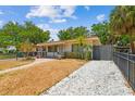Charming single-story home with a well-maintained front yard, featuring stone driveway, mature trees, and inviting curb appeal at 120 Bosphorous Ave, Tampa, FL 33606