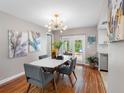 Dining room featuring modern chandelier, table, and view to the backyard at 12920 124Th Ave, Largo, FL 33774