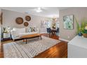 Bright living room with hardwood floors, stylish rug, and comfortable seating area at 12920 124Th Ave, Largo, FL 33774
