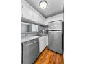 Kitchen featuring stainless steel appliances, sleek countertops, ample cabinet space, and gleaming hardwood floors at 1301 S Howard Ave # A22, Tampa, FL 33606