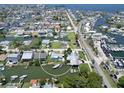 Wide aerial shot showcasing the neighborhood with canal access and boating docks at 13928 Raie Ave, Hudson, FL 34667